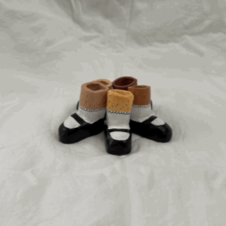 A stop motion animation of hairy leg sculptures wearing mary jane shoes